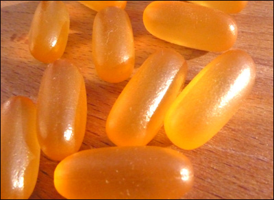 Fish oil tablets covered in a film to prevent fish smell and taste.